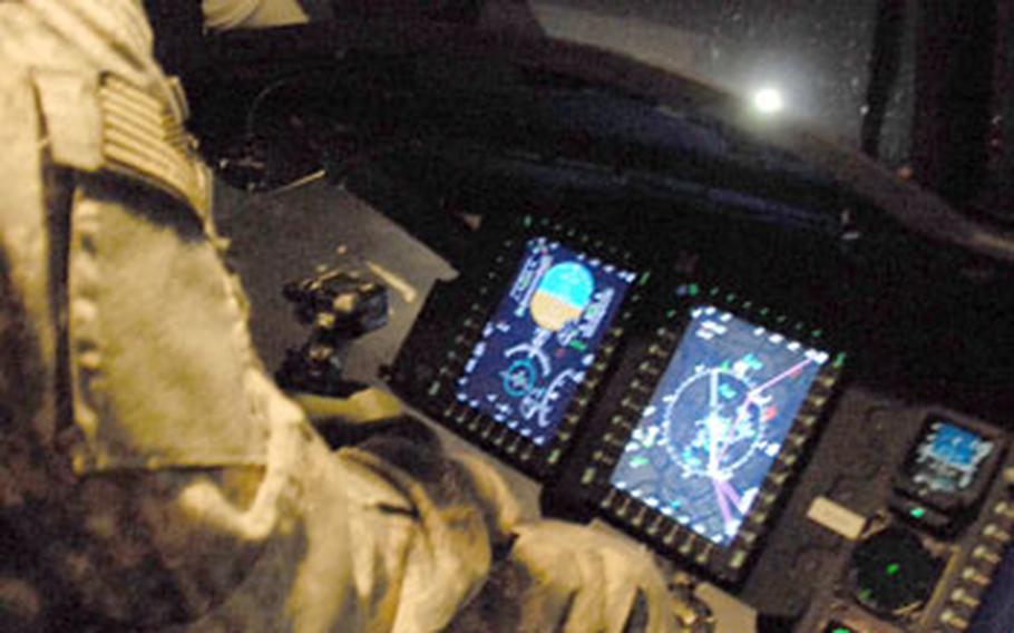 Chief Warrant Officer 3 Brandon Tipton, of Company B, 2nd Battalion, 4th Combat Aviation Brigade, 4th Infantry Division, pilots a Chinook helicopter during a nighttime mission around Baghdad.
