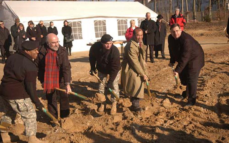 Col. Richard M. Pastore, center, along with garrison and local Germans officials, break ground during a ceremony to commemorate the start of construction on the Panzer Hotel at the U.S. Army Garrison in Stuttgart.