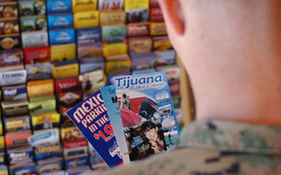 A Marine at the Entertainment Ticket Office looks over brochures that give tips on how to stay safe while visiting border towns in Mexico like Tijuana.