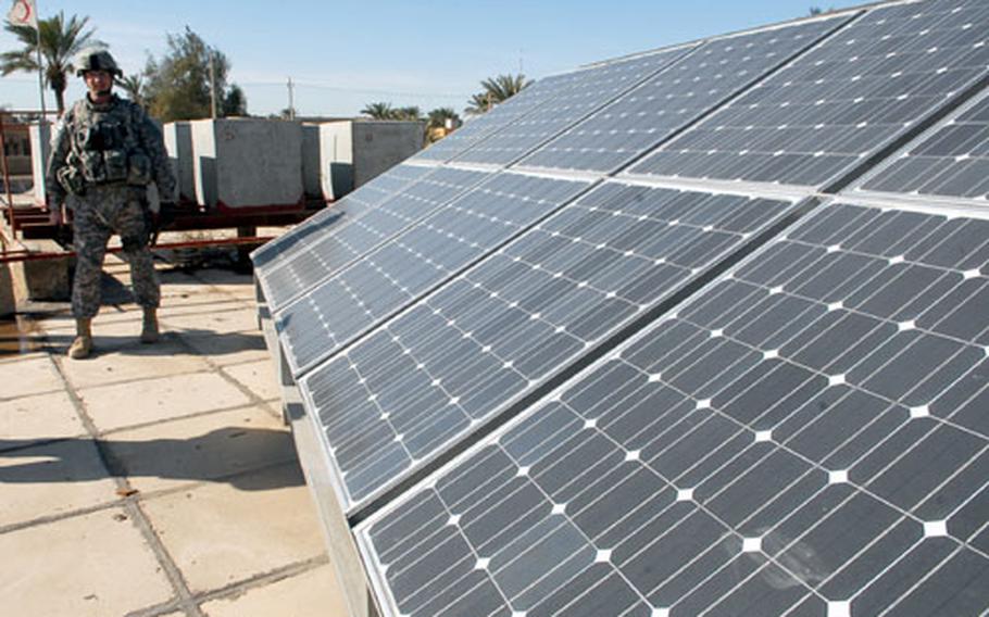 Col. Joseph Martin, commander of 2nd Heavy Brigade Combat Team, 1st Infantry Division, inspects solar panels sit on roof of a clinic in Baghdad’s Amariyah neighborhood Jan. 15. The clinic is one of nearly two dozen solar projects that the military is doing in northwest Baghdad as an attempt to restart essential services without drawing on the overtaxed national power grid.