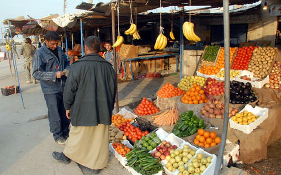 Fresh fruit, much of it from Syria, is sold at a market next to the Abu Ghraib prison. Shop owners hope to benefit from the reopened facility, which became known for a U.S. detainee abuse scandal in 2004.