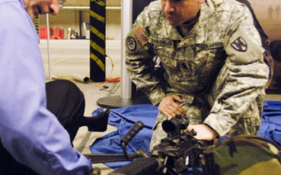 Army Sgt. Maj. Tomas Gonzales, the 21st Theater Sustainment Command’s operations sergeant major, checks modifications to a weapon system at an exhibit in Kaiserslautern, Germany, on Tuesday. Gonzales was among dozens of Army enlisted leaders who met earlier this week and discussed “The Year of the Noncommissioned Officer.”