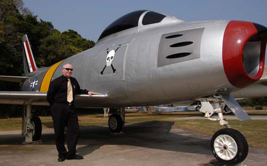 James Burrett, 18th Wing historian, poses in front of an F-86 Sabre at Kadena Air Base’s air park. Restoring aircraft displayed in the park to historical accuracy is one of Burrett’s current projects.
