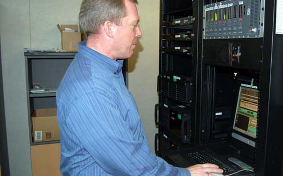 Dan Valler, American Forces Network-Korea chief of network radio, uses a computer that lets him alter programming at AFNK headquarters in Seoul.