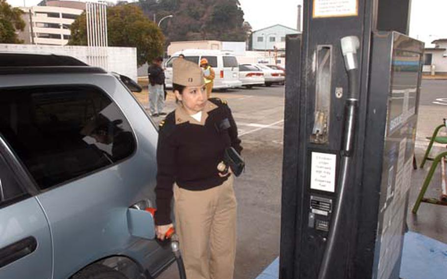 Navy Lt. Sharon Quallio, of the Branch Health Clinic, Naval Air Facility Atsugi, Japan, fills her tank Thursday at the Yokosuka Naval Base Autoport.