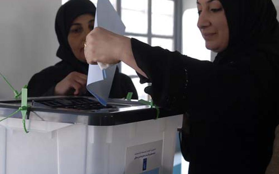 An Iraqi woman votes in Baqouba, where there were no reports of violence. Early reports indicated a low turnout in the city.