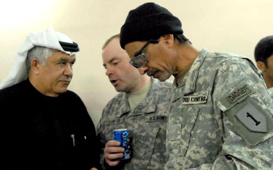 Interpreter Hassan Benkato, right, translates a conversation Tuesday for Lt. Col. John Vermeesch, center, commander of 1st Battalion, 18th Infantry Regiment, at the Kadhamiyah District Council. U.S. interpreters who work for Global Linguist Systems are facing pay cuts because of changes to the company’s contract with the Intelligence and Security Command.