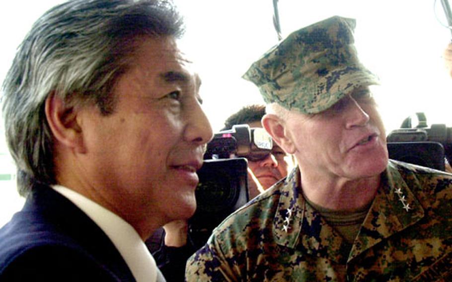Hirofumi Nakasone, Japan’s minister of Foreign Affairs, left, speaks with Lt. Gen. Richard C. Zilmer, commander of Marine Corps Bases Okinawa, during a brief tour of Camp Schwab on Sunday.