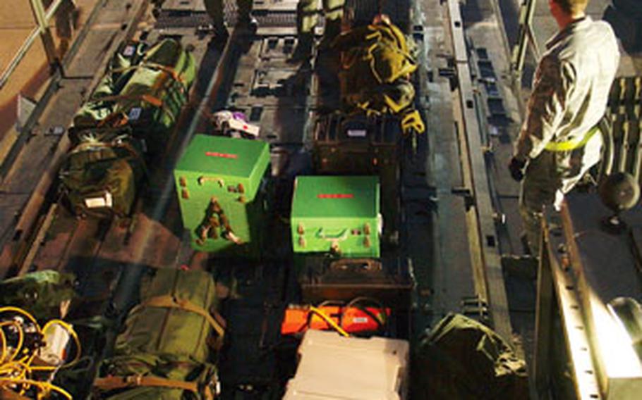 Airmen from the 18th Aeromedical Evacuation Squadron load medical equipment on a K-Loader in preparation for simulated mission during the 18th Wing’s Turkey Shoot competition.