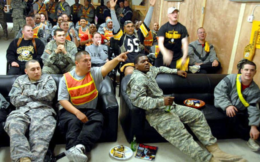 Pittsburgh Steelers fans cheer during the opening quarter of the Super Bowl at about 2:30 a.m. Monday at Forward Operating Base Delta in Kut, Iraq.