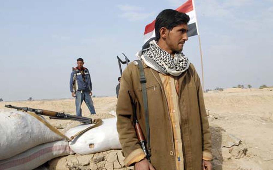 Iraqi “recruits” monitor a checkpoint near the farming village of Sari Tapa in northeastern Diyala province. The men are part of a new program in Diyala province that hires young men to man checkpoints.