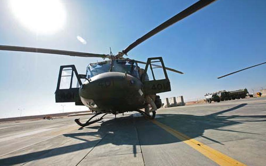 A Canadian pilot prepares a Griffon escort helicopter for a mission at Kandahar Airfield, Afghanistan. Canadian forces started operating a contingent of helicopters and unmanned aerial vehicles in December to support their troops and other NATO forces in southern Afghanistan.