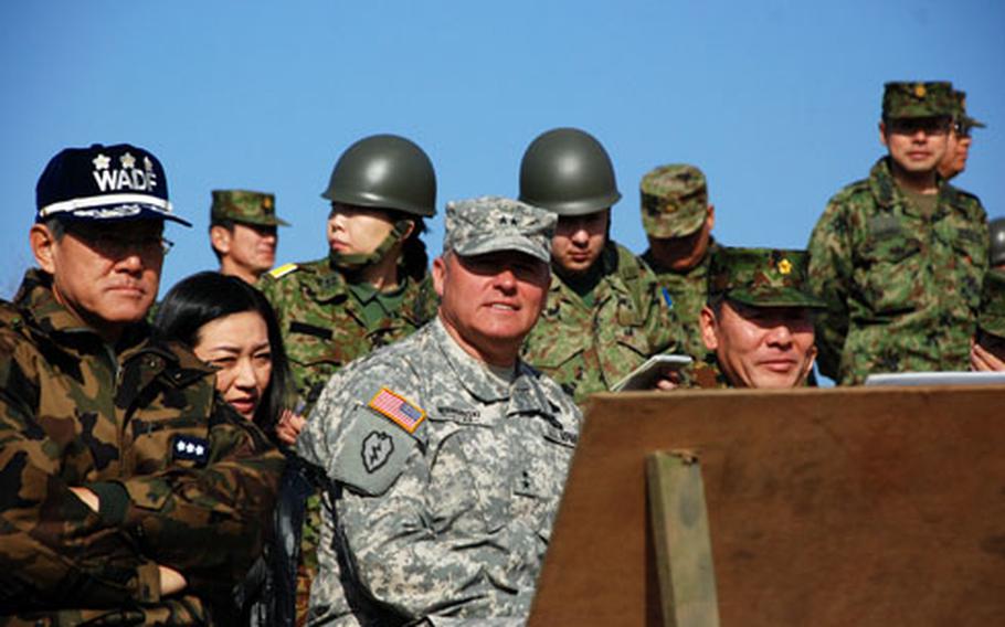 Lt. Gen. Osamu Onoda, commander Western Air Force JASDF, left; Maj. Gen. Frank Wiercinski, USARJ commanding general; and Lt. Gen. Kazuhito Mochida, Western Army JGSDF commander, observe training during exercise Orient Shield.