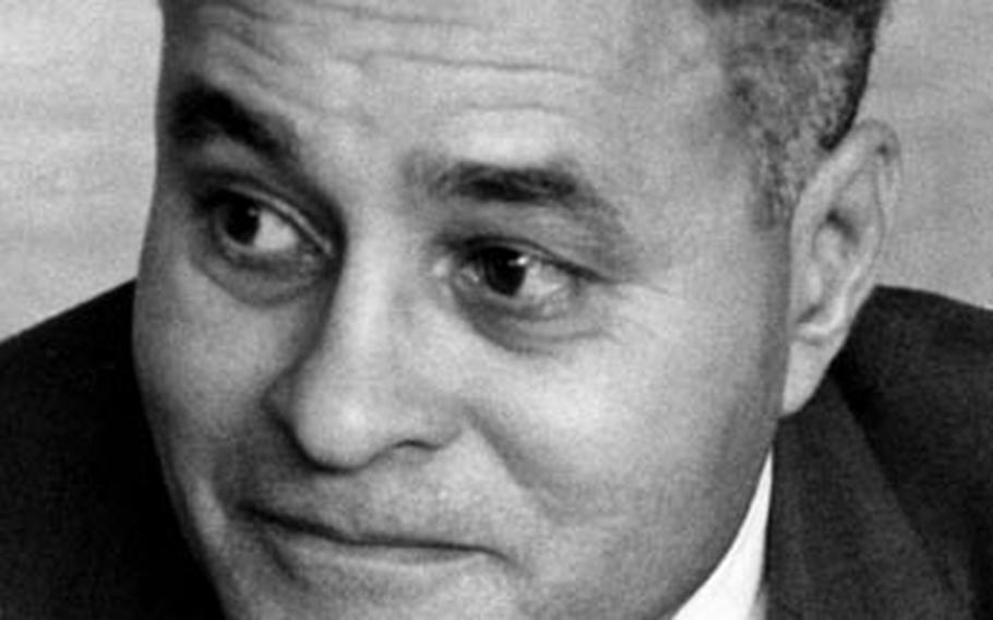 Dr. Ralph Bunche talks to reporters in Tokyo in March, 1960.