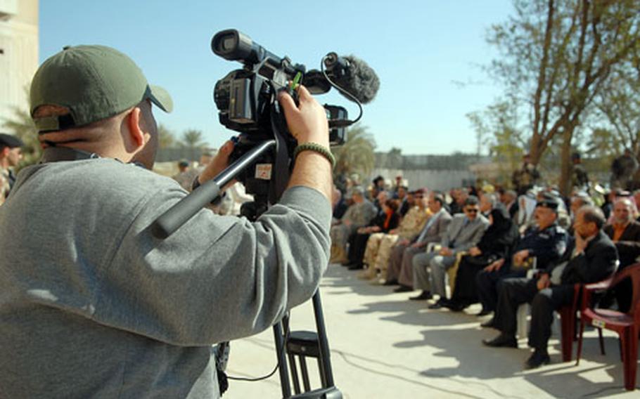 Ali Hassham, a cameraman with Al-Ayn Media, films a ceremony marking the transfer of an American base to Iraqi control Monday in Baghdad’s Adl neighborhood. American leaders are working with Arabic media to speak directly to the Iraqi people about their country’s growing sovereignty.