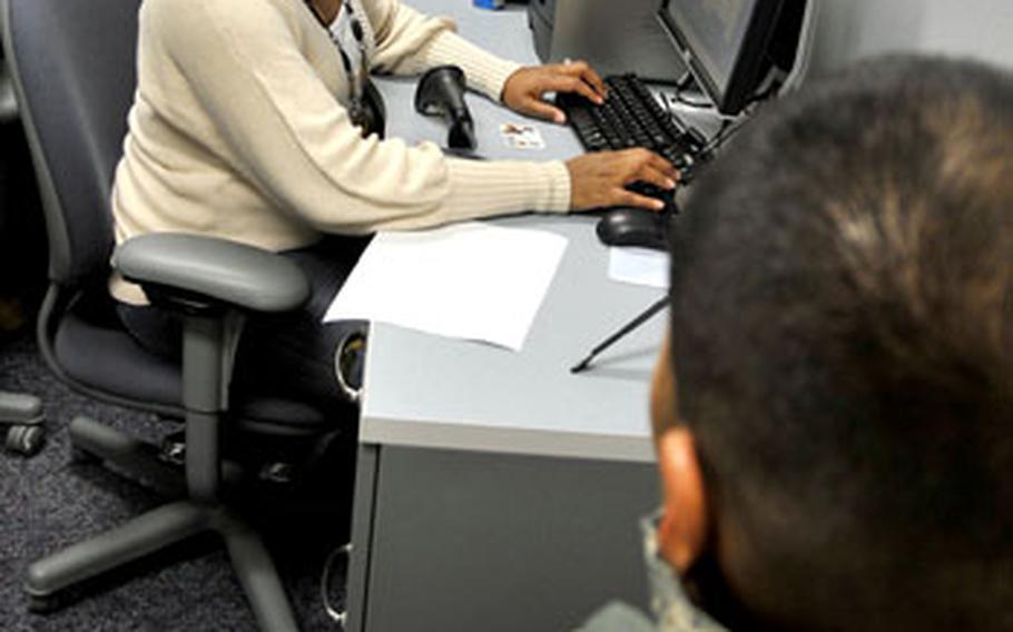 Queena Knowles, 35th Security Forces squadron, registers Master Sgt. Victor Vicuna&#39;s identification card for the Defense Biometric Identification System (DBIDS) last month at Misawa Air Base, Japan.