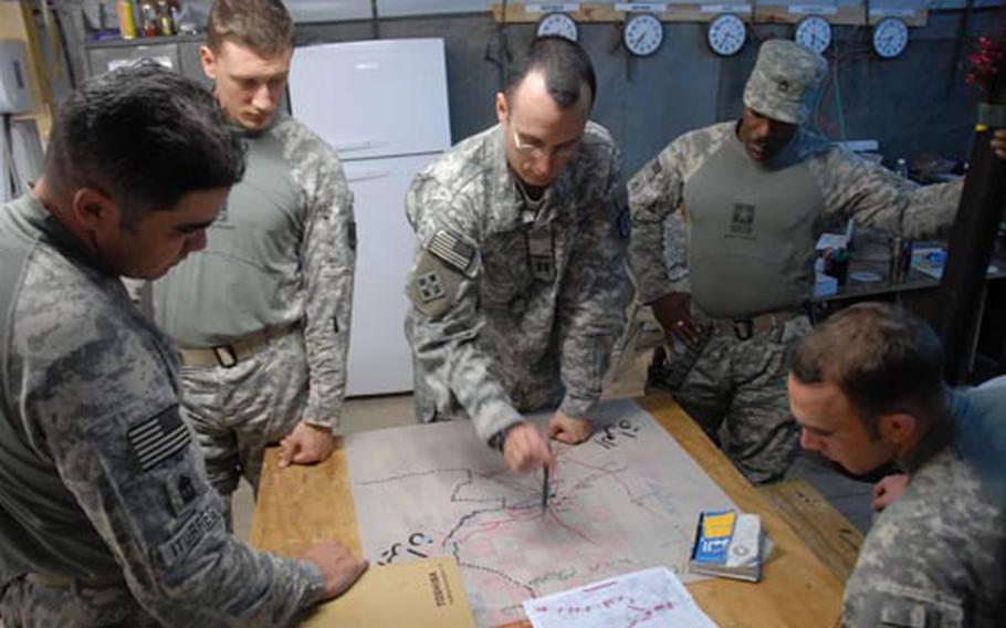 Capt. Adam Ropelewski discusses changes to an upcoming mission with members of Battery B, 2nd Battalion, 20th Field Artillery Regiment. The unit conducts joint missions with Iraqi soldiers in al-Mutanabi, Iraq.