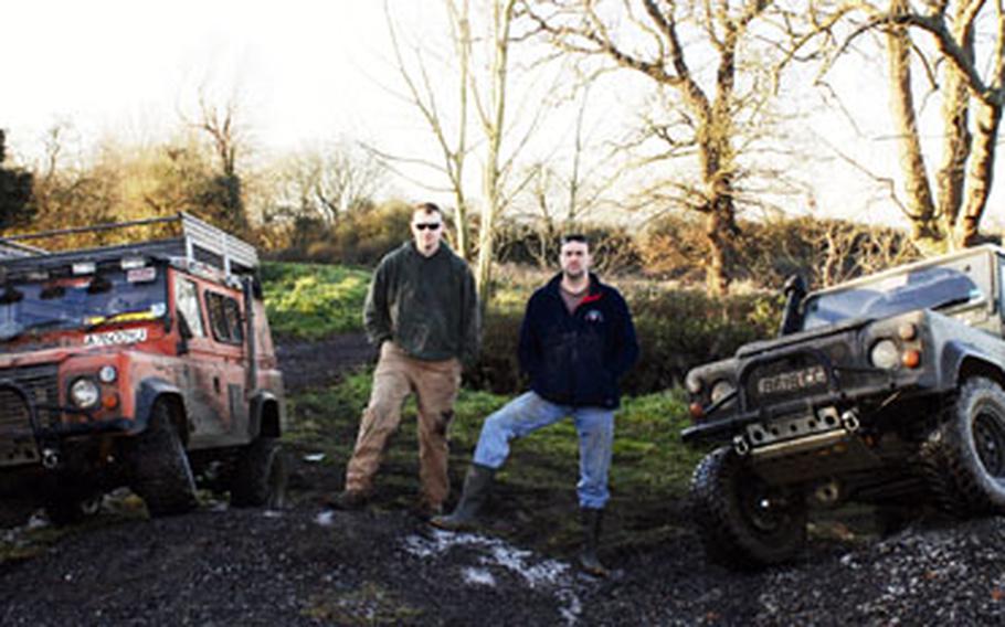 Master Sgt. Chris Egbert, left, and Tech. Sgt. Michael Philpot stand in front of their Land Rover trucks. The two will become the first all-American team to compete in the Macmillan 4X4 U.K. Challenge, a cross-country rally race for charity. The two have been gearing up Egbert’s truck in anticipation of the event next month.