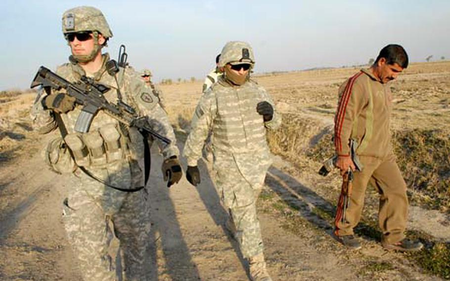 Rahim Muhammed Mahmoud, far right, a Diyala province "Sons of Iraq" leader, leads Capt. Timothy Walton, far left, to the site of a rocket attack outside the town of Nahr al Imam. The Iraqi security forces have been slow to give jobs to group members in Diyala.