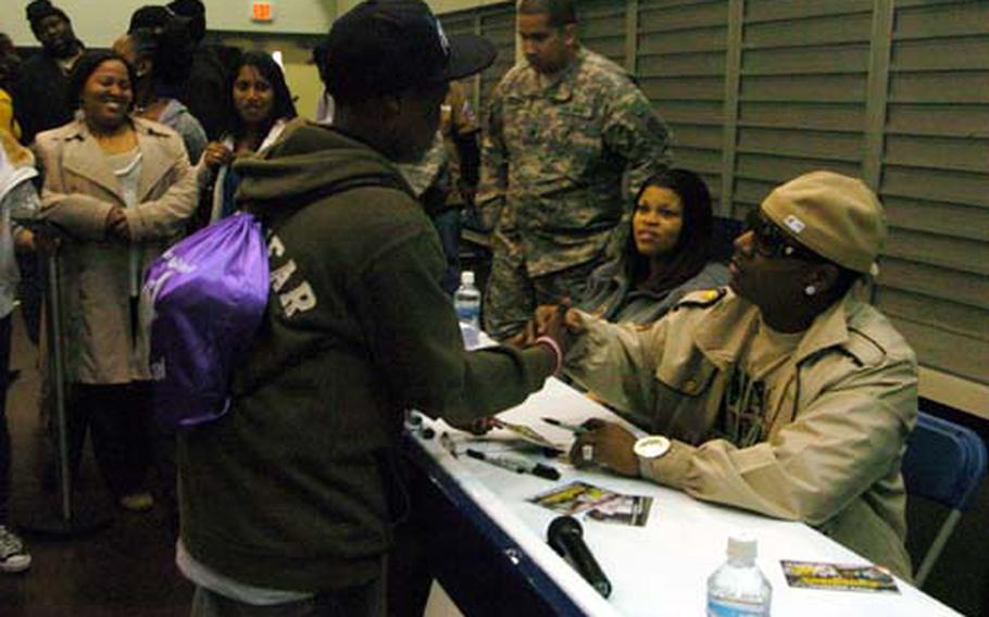Thirteen-year-old Keanan Little shakes hands with Yung Joc during the famous rapper's visit to the Camp Zama, Japan, Youth Center on Thursday. 'Joc' will be performing and meeting fans at Far East military bases throughout the month.