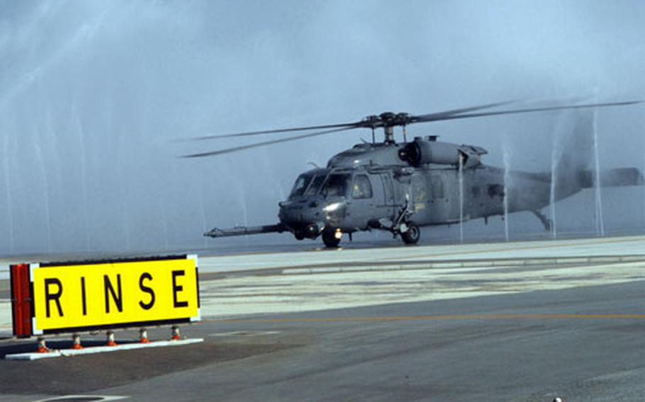 An HH-60 Pave Hawk runs through a "bird bath" Monday to prevent saltwater corrosion after an air refueling mission off the coast of Okinawa during exercise Cope Angel. Cope Angel is a joint rescue exercise between members of the U.S. Air Force, U.S. Marine Corps and the Japanese Air Sel-Defense Force. The units practiced responding to mass-casualty situations and aircraft recovery, officials said.