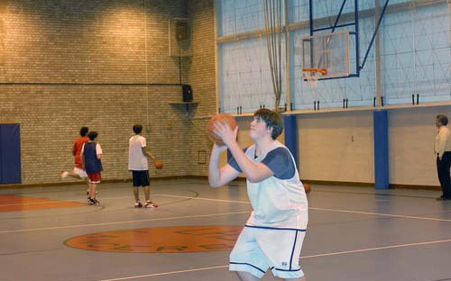 Lakenheath High School freshman Paul Federinko works on his shooting during practice last week. At 6 feet, 4 inches tall and 240 pounds, Federinko is the biggest player on the Lancers hoops squad. He helped Lakenheath beat Kaiserslautern in his second game with the varsity team.