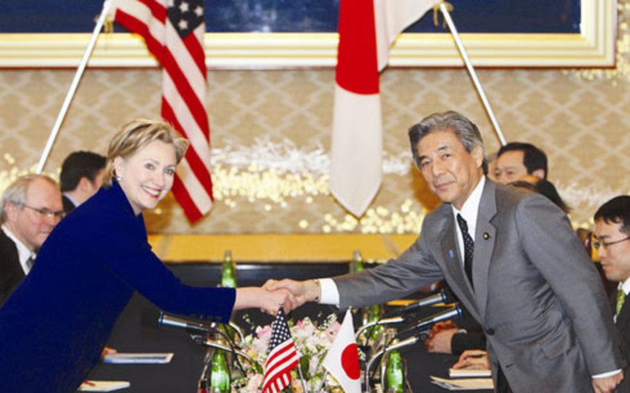 Secretary of State Hillary Rodham Clinton, left, shakes hands with Japan Foreign Minister Hirofumi Nakasone prior to their meeting at the Iikura Guest House on Tuesday in Tokyo.