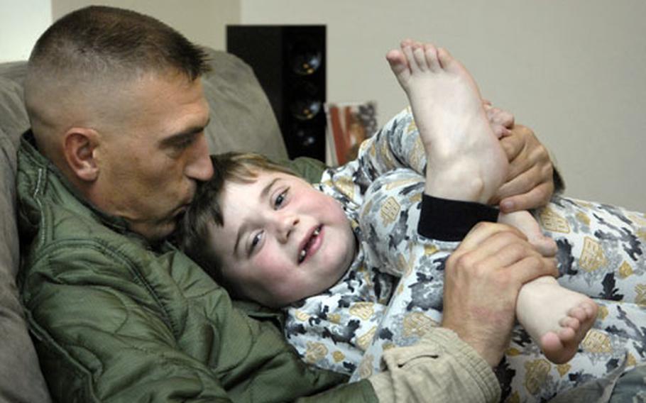 Sgt. Chris Bartell plays with his son, Jacob, before bedtime Oct. 29th, 2008 in their base house on Ft. Drum, N.Y.