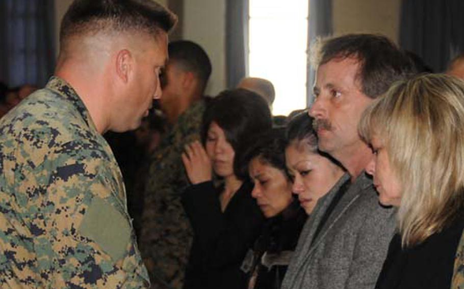 Lt. Col. Oliver B. Spencer, commanding officer of 3rd Reconnaissance Battalion, presents the Bronze Star with V for valor awarded posthumously to Sgt. Michael H. Ferschke Jr. to his parents, Michael and Robin Ferschke, right, at a memorial service for the sergeant Friday at Camp Schwab.