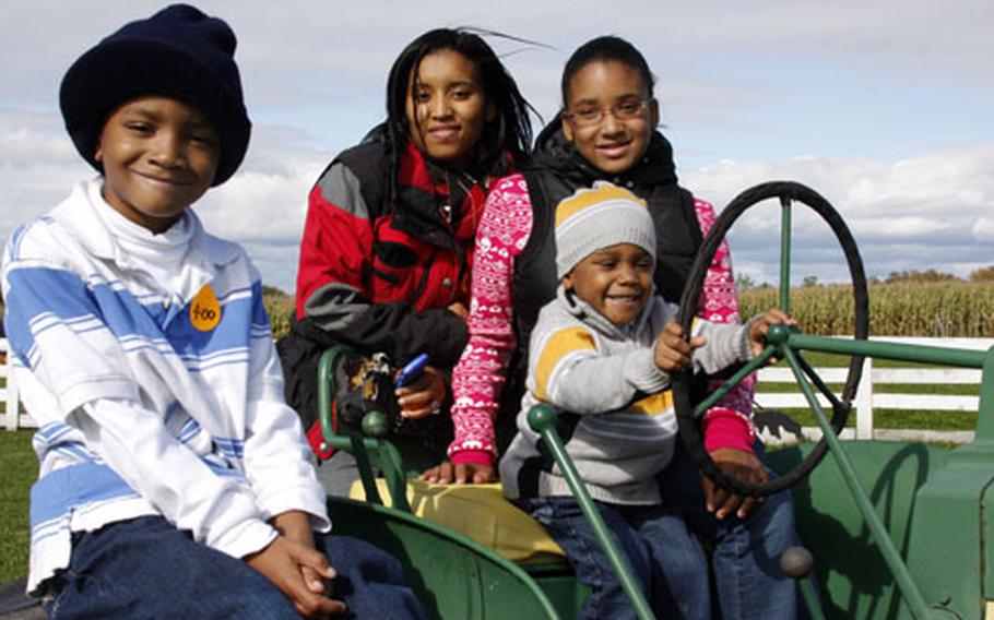 The Brown family on an Oct. 5 outing at Old McDonald’s Farm in Sackets Harbor, near Fort Drum, N.Y. Three-year-old Malik sits at the wheel of the tractor as Justin, 7, Marcetia, in back, and Jasmine, 11, look on.