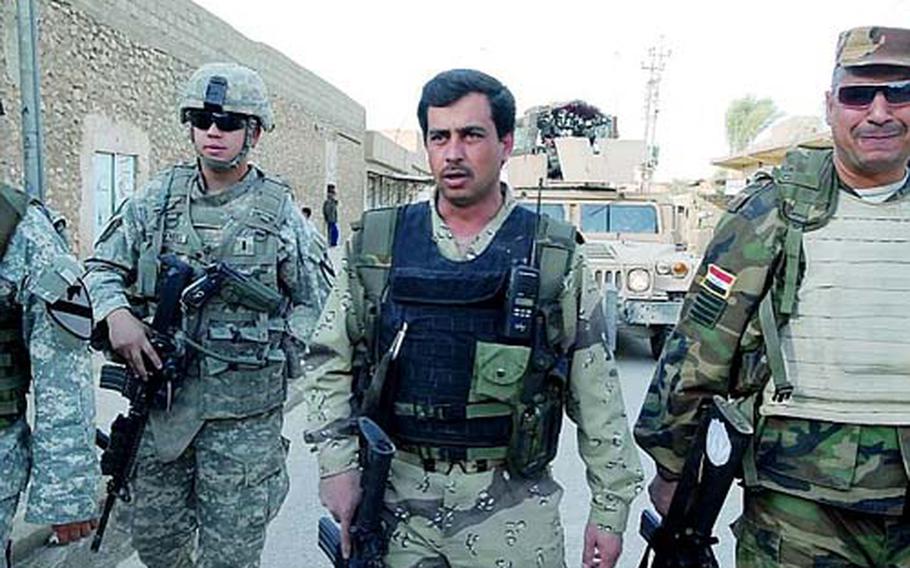 1st Lt. Corey Mathews, left, patrols with his Iraqi army counterparts in the city of Muhallabiyah, west of Mosul.