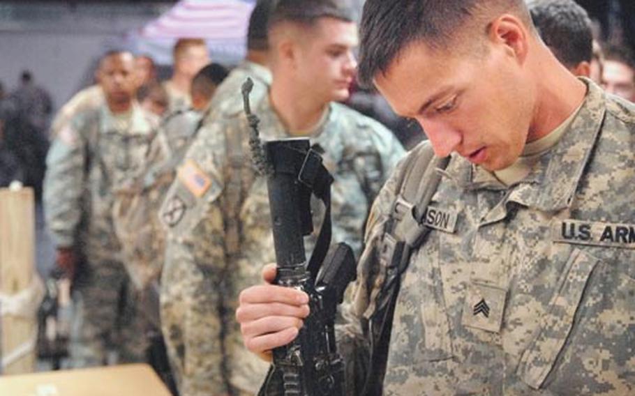 Sgt. David Johnson, a soldier assigned to Company B, 2nd Battalion, 22nd Infantry Regiment, turns in his weapon during in-processing near the air field at Ft. Drum Oct. 26th, 2008. After doing his extra time, courtesy of stop-loss, Johnson plans to join his family business back home in Washington state early December. Johnson just returned home from his deployment to southern Kirkuk, Iraq.