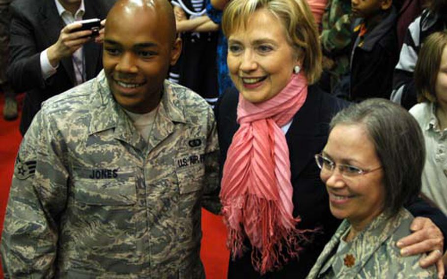 Senior Airman Andrew Jones (left) and Maj. Janis Dashner pose for a picture with Secretary of State Hillary Rodham Clinton during a visit Yokota Air Base on Sunday.
