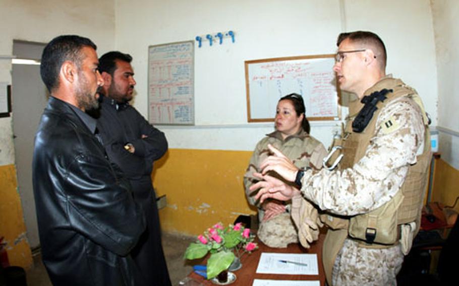 Martell hears a claims case by Iraqi lawyer Fahig Mohammed Beder, front left, and his client in Rutbah.