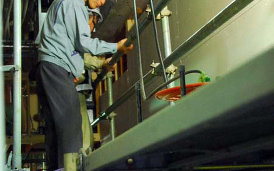 Workers build the new Chili&#39;s expected to open at Sasebo Naval Base this fall.