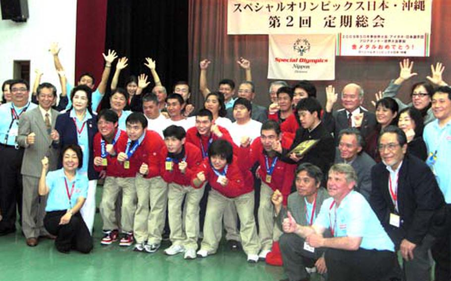 Members of the Okinawa chapter of Special Olympics Japan on Tuesday celebrate the floor hockey team's gold from the Special Olympics Winter World Games in Boise, Idaho, earlier this month.