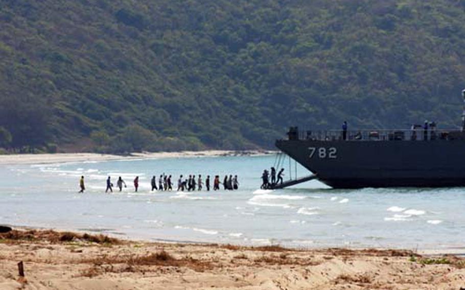 Volunteer Thai nationals board a Royal Thai landing ship Feb. 14.