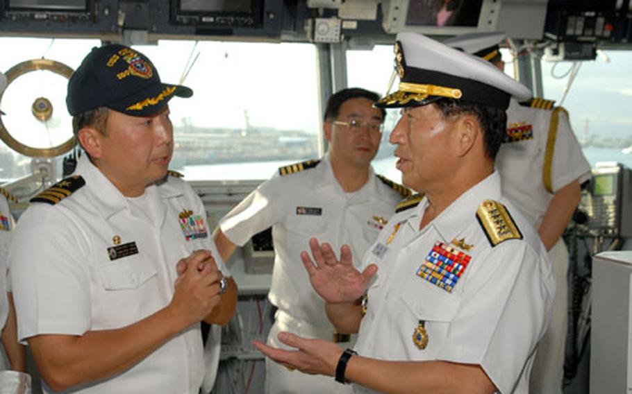 Cmdr. Heedong Choi, left, talks with South Korean Chief of Naval Operations Adm. Jung Ok-keun, right, at Pearl Harbor in January.