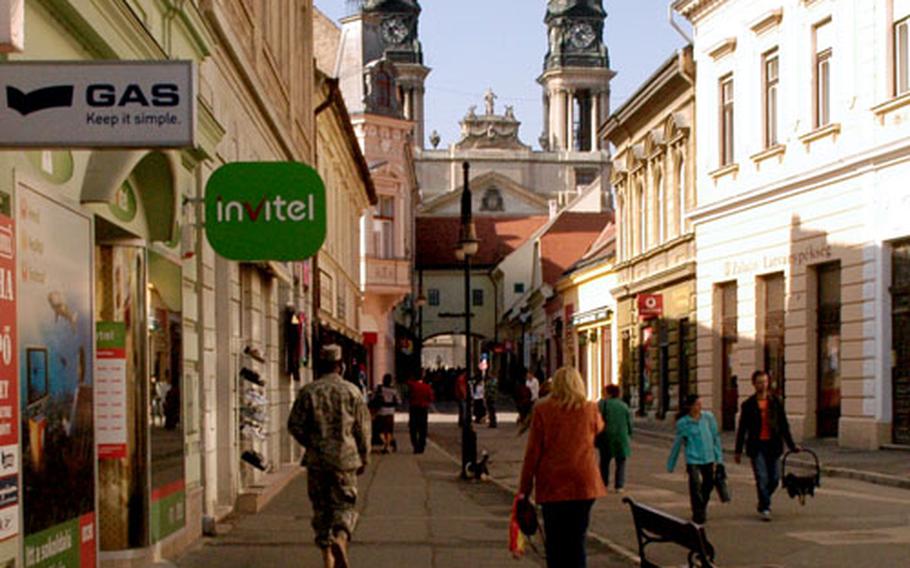 U.S. airmen are becoming a common sight on the streets of Papa, a small town of 32,000 in western Hungary. Personnel from 10 NATO countries and two non-NATO countries have joined forces to form the Strategic Airlift Capability project, a multinational consortium that involves a Heavy Airlift Wing of three C-17s. With about 150 personnel, plus family members and contractors, the international crowd is adding an economic jolt to the sleepy city 100 miles west of Budapest.