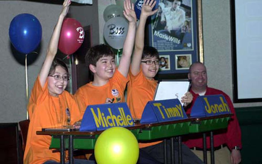 International Christian School students Michelle Nolan, Timmy Rose and Jonah Yang try to get picked to assist a contestant during Monday&#39;s "Are You Smarter Than A Fifth-Grader" event at Camp Red Cloud.
