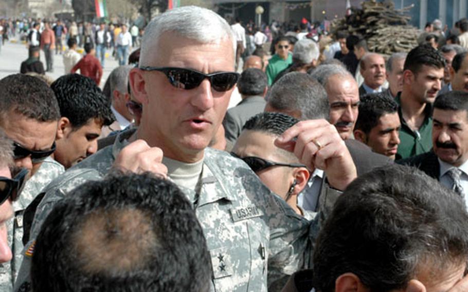Maj. Gen. Mark P. Hertling, commander of Multi-National Division-North, talks to local citizens as he tours Sulimaniyah, Iraq, in March, 2008.