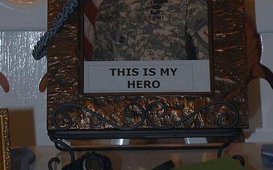 enw11hatley2
Schweinfurt, Germany
Dan Blottenberger/Stars and Stripes
A photo of Master Sgt. John Hatley sits behind dozens of commander's coins at the home Schweinfurt home of Kim Hatley. Last month, John Hatley was convicted of premeditated murder of four Iraqi detainees. Now, Kim Hatley, must pick up the pieces of her life as her husband faces decades in prison. 