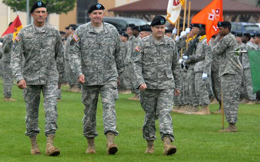 Outgoing 1st Armored Division commander Maj. Gen. Mark Hertling, V Corps commander Lt. Gen. Kenneth Hunzeker and incoming 1st AD commander Maj. Gen. Terry Wolff, from left, inspect the troops at the beginning of the division&#39;s change of command ceremony in Wiesbaden, Germany, on Tuesday.