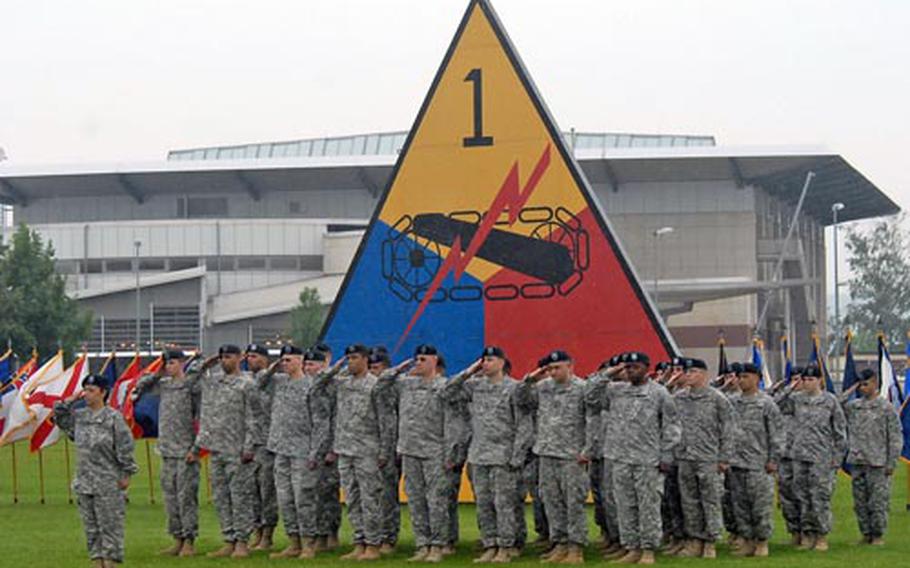 Soldiers of the 1st Armored Division salute during the playing of the national anthem at the division&#39;s change of command ceremony in Wiesbaden, Germany, on Tuesday. Maj. Gen. Terry Wolff replaced Maj. Gen. Mark Hertling as commander.