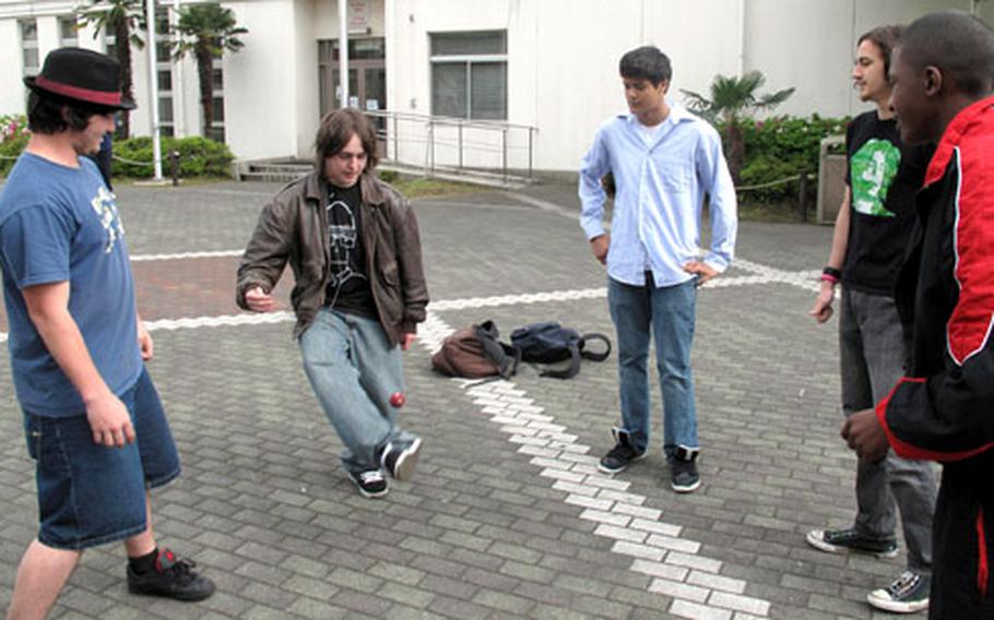 Teens play hacky sack in the Kinnick High School courtyard on Yokosuka Naval Base, Japan.