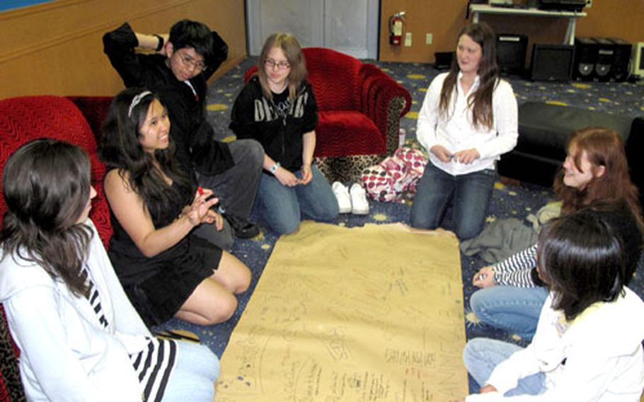 Teens from the anime club at Yokosuka Naval Base brainstorm ideas at the Teen Center.