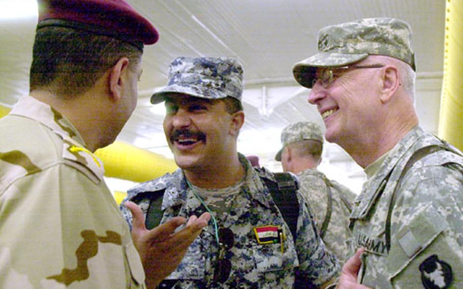 Maj. Gen. Rick C. Nash (right), commander of the 34th Infantry Division, talks with leaders of Iraqi security forces after a transfer of authority ceremony at Contingency Operating Base Basra. Nash now commands Multi-National Division South, which includes the nine southernmost provinces in Iraq and Basra. The area includes the country&#39;s most productive oil fields and holiest sites.