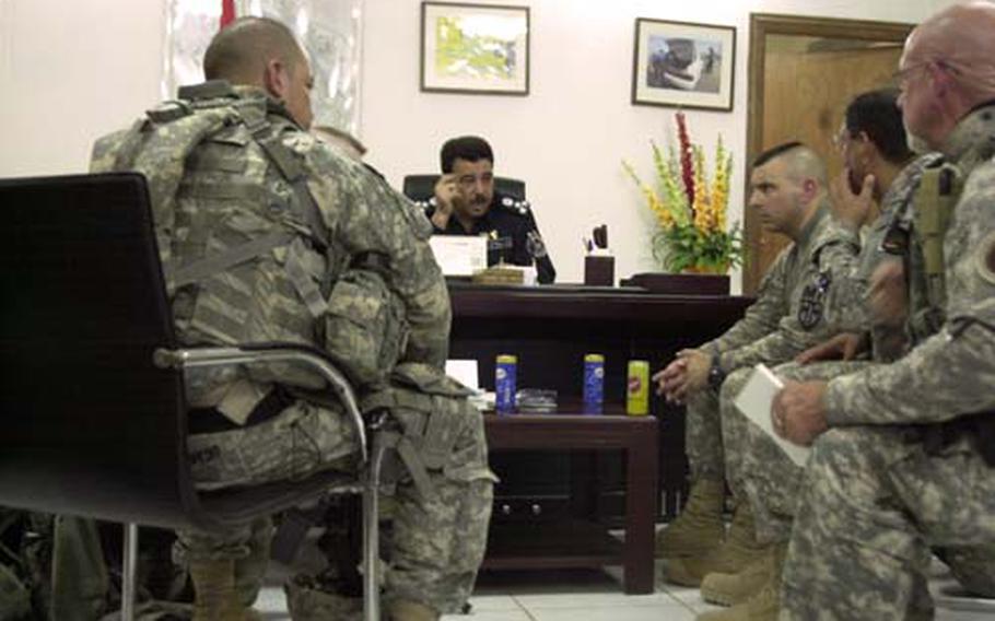 Members of the 793rd Military Police Battalion listen as the No. 2 ranking police officer in Basra province talks about an upcoming training class for specialized officers. The U.S. Army battalion is a headquarters unit preparing to return to Bamberg, Germany, at the end of a 15-month deployment.