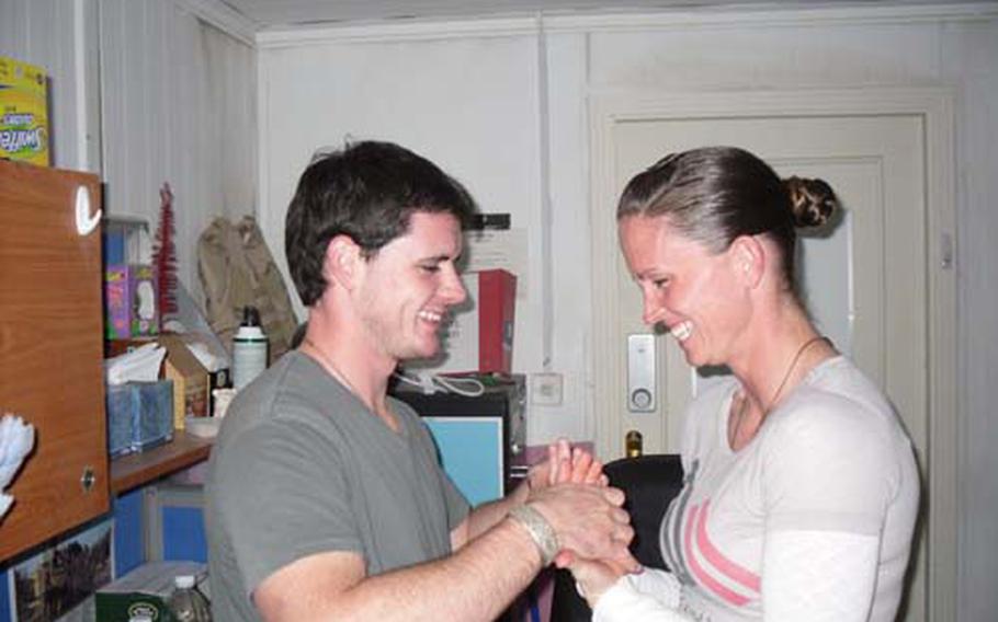 The Murphys recite their wedding vows via speaker phone from a military office in Baghdad. Two people stood in for them during their official wedding ceremony on April 3, and the ordained minister who presided over their proxy ceremony also led the couple through their vows via phone from Montana.