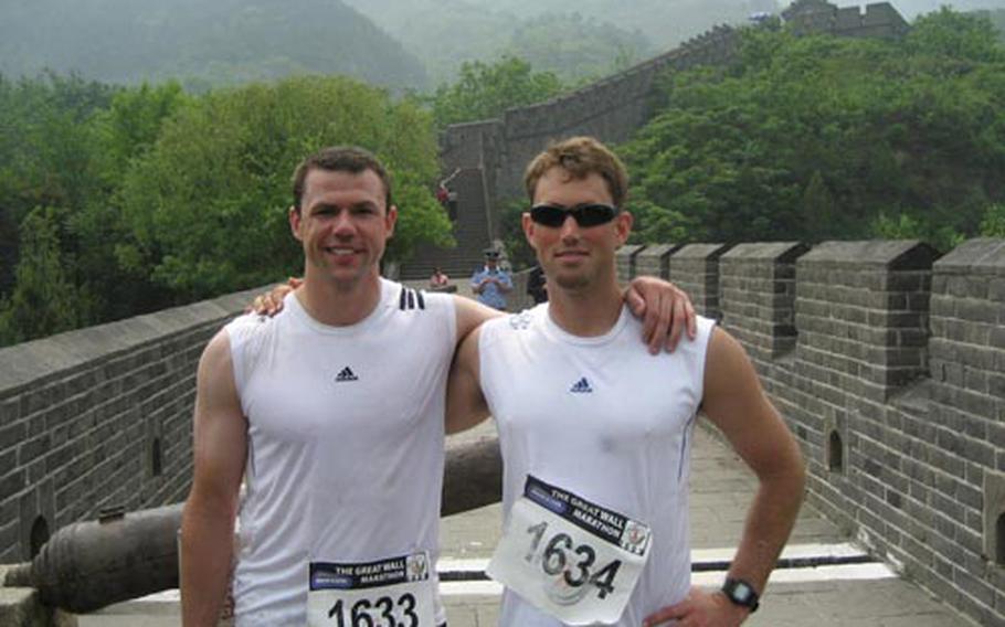 Capts. David Dixon, left, and Josh Miller, both with the 31st Marine Expeditionary Unit, stand on the Great Wall of Chaina on May 16, when the two and a third Marine captain, ran the Great Wall of China Marathon.